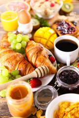 Breakfast- coffee cup,  croissant,  cereal and fruit