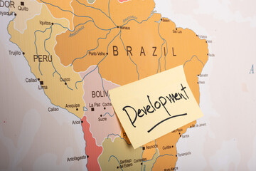 Development written on a sticky note attached with the Brazil country on world map.