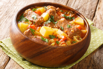 Delicious Italian beef stew with wine, potatoes, carrots, onions and celery close-up in a bowl on the table. horizontal