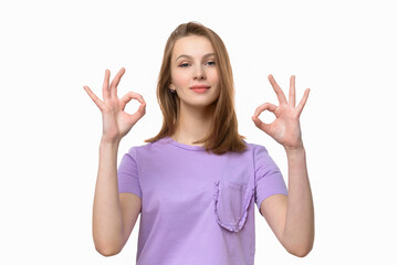Fototapeta premium Beautiful young woman wearing casual tshirt showing OK sign and smiling