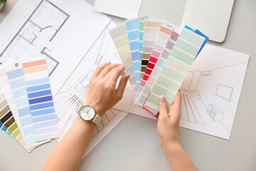 Female interior designer with color palettes in office