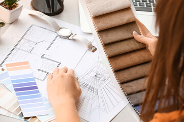 Female interior designer with fabric samples in office