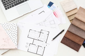 House plans and fabric samples on light background