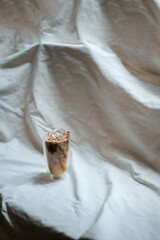 glass of coffee with milk on a white canvas