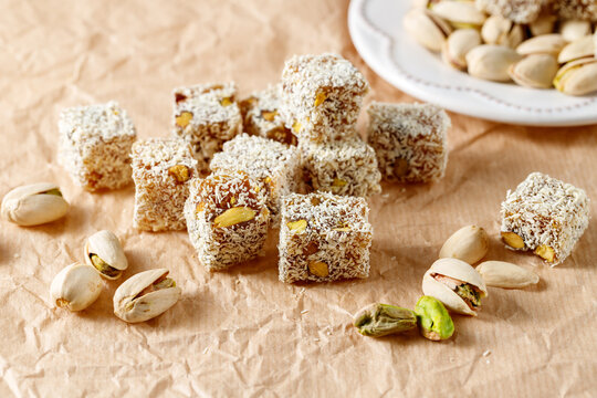  Traditional  oriental sweets rahat lokum and pistatio nuts scattered on paper