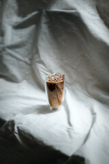 glass of coffee with milk on a white canvas