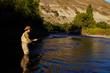 Senior fishing in a river