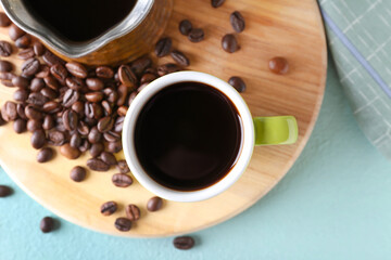 Cup of tasty hot coffee on color background