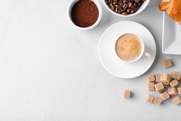 Composition with cup of hot coffee on light background