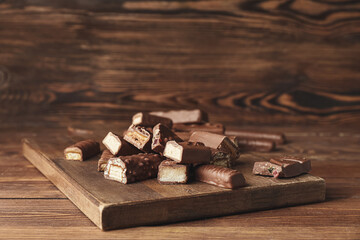 Sweet chocolate bars on wooden background
