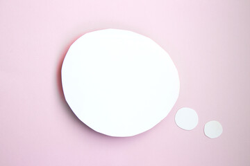 White paper speech bubble concept. Cartoon speech with clipping path in the form of a circle on bright pink background with contrasting shadow
