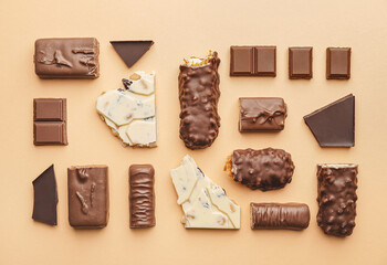 Composition with different chocolate on color background