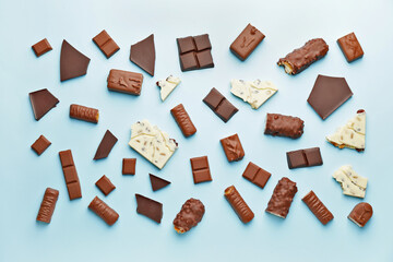 Composition with different chocolate on color background