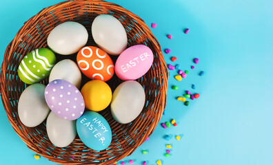 Fototapeta na wymiar Easter decorations,Easter eggs in the basket on blue background.