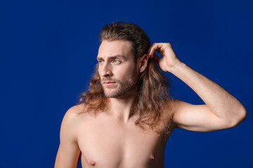 Handsome young man on color background