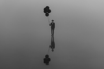 surreal single man in a suit with a hat with balloons in his hand on the water