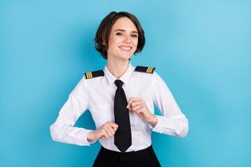 Photo of charming nice stunning young lady wear tie fix uniform pilot isolated on pastel blue color background - obrazy, fototapety, plakaty