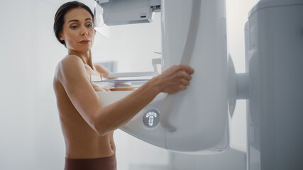 Fototapeta na wymiar In the Hospital, Portrait Shot of Topless Multiethnic Female Patient Undergoing Mammography Screening Procedure. Healthy Adult Female Does Cancer Preventive Mammogram Scan in Radiology Room.