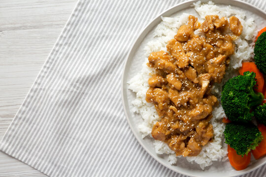 Homemade Orange Chicken With White Rice, Broccoli And Carrot On A Plate, Top View. Flat Lay, Overhead, From Above. Space For Text.