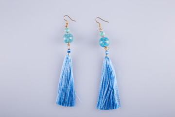 Beautiful earrings on a light gray background. Costume jewelry. 