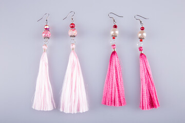 Beautiful earrings on a light gray background. Costume jewelry. 
