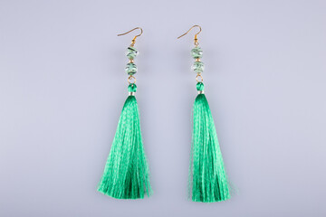 Beautiful earrings on a light gray background. Costume jewelry. 