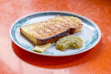 French toast with butter and kaya on a plate