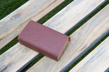 A sanding block on a wooden bench ready to sand down, home improvement woodworking concept