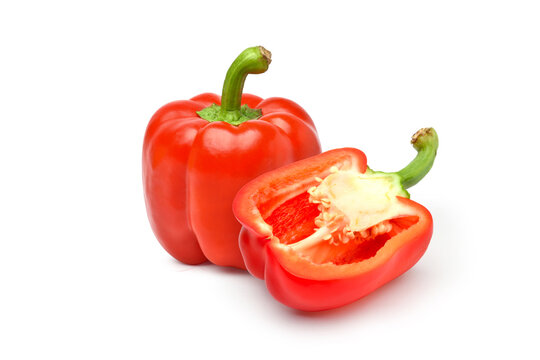 Red bell pepper with cut in half isolated on white background.
