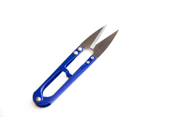 Blue scissors to cut the thread isolated on white background