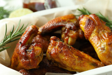 Baking tray with baked chicken wings, close up