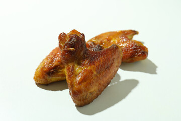 Baked chicken wings on white background, close up