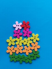 flower shaped wooden buttons on blue background