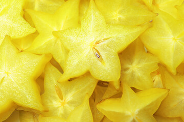 Pile of delicious carambola slices as background, top view