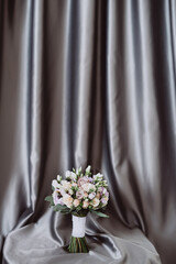 wedding bouquet on gray fabric background
