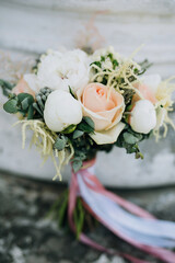closeup wedding bouquet of roses and peonies