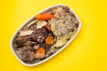 typical portuguese dish meat, smoked sausages and vegetables on the dish
