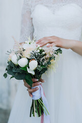the bride touches the bouquet