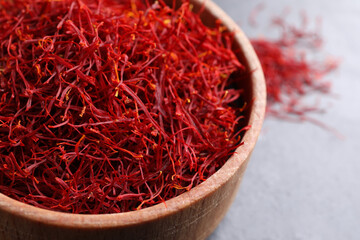 Dried saffron in bowl on table, closeup