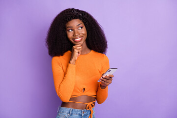 Portrait of lovely minded cheerful wavy-haired girl using device creating new post smm blogging...