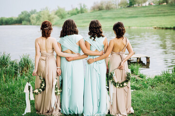 girls in identical dresses on the background of the lake