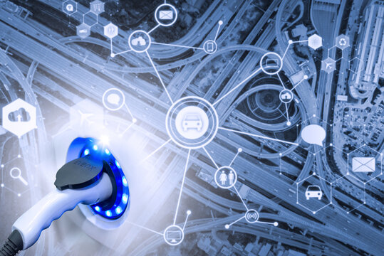 Electric Vehicle , Smart Car , Air Pollution And Reduce Greenhouse Gas Emissions Concept. Double Exposure Of Charging Electric Car With Power Cable Supply Plugged In And City.