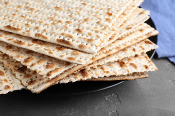 Stack of matzos on grey table, closeup