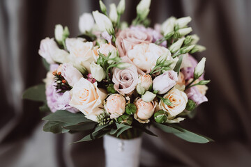 close-up of wedding bouquet on gray fabric background