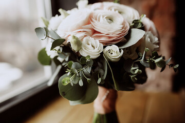 close-up wedding bouquet of white roses and runculus