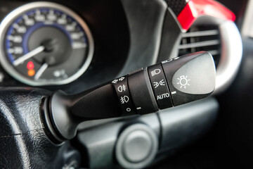 Switch off lights in a car. close-up Car integrated turning indicator with headlight switch toggle.