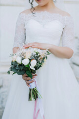 the bride touches the bouquet