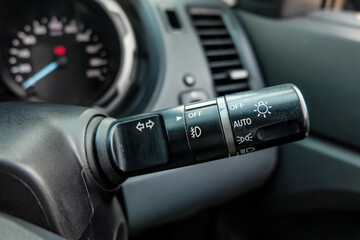 Switch off lights in a car. close-up Car integrated turning indicator with headlight switch toggle.