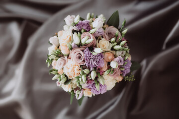 top view of wedding bouquet on gray fabric background