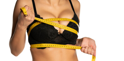 Woman measures he big breasts with a measuring tape